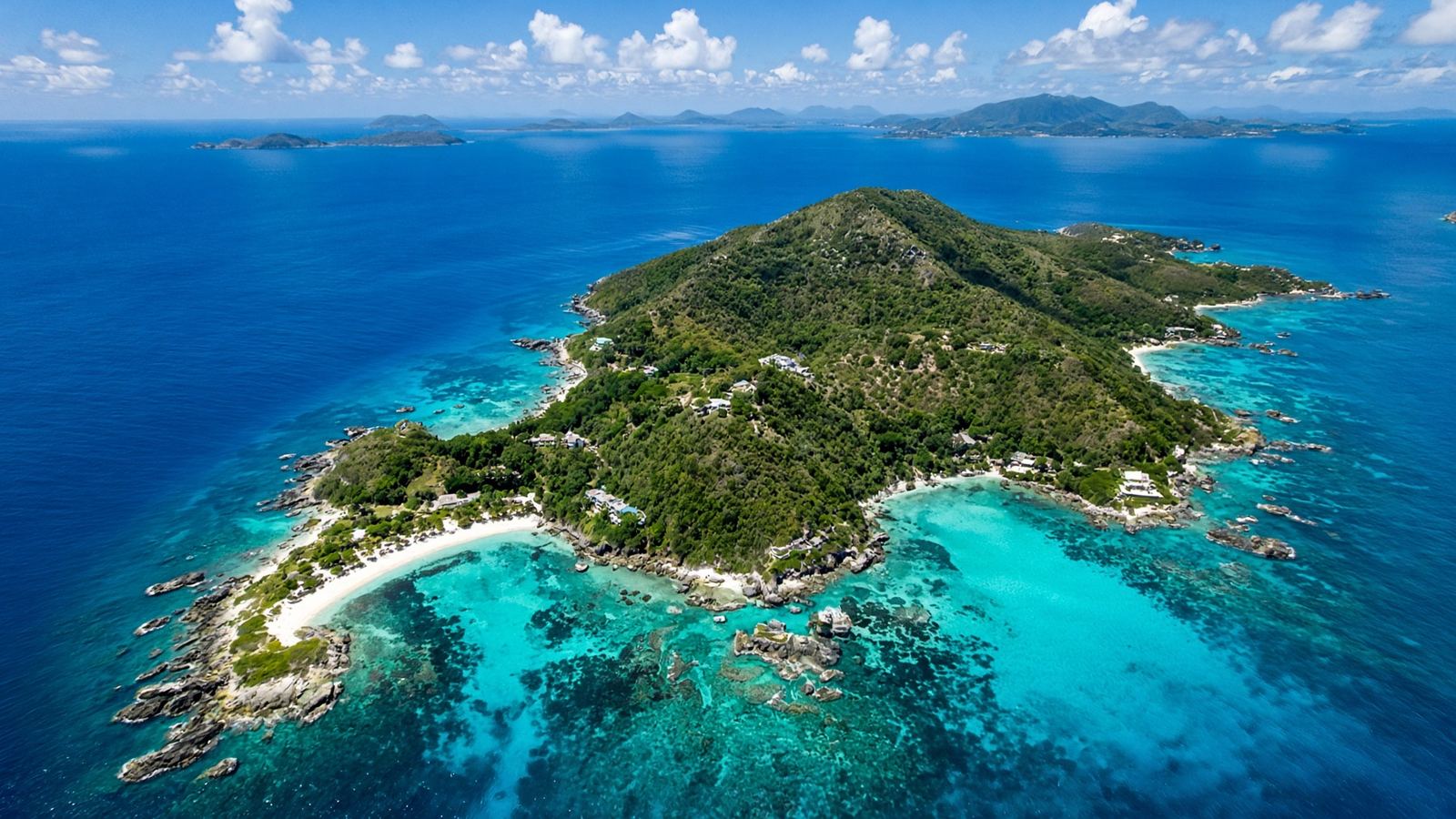 Green island ringed by coral reef